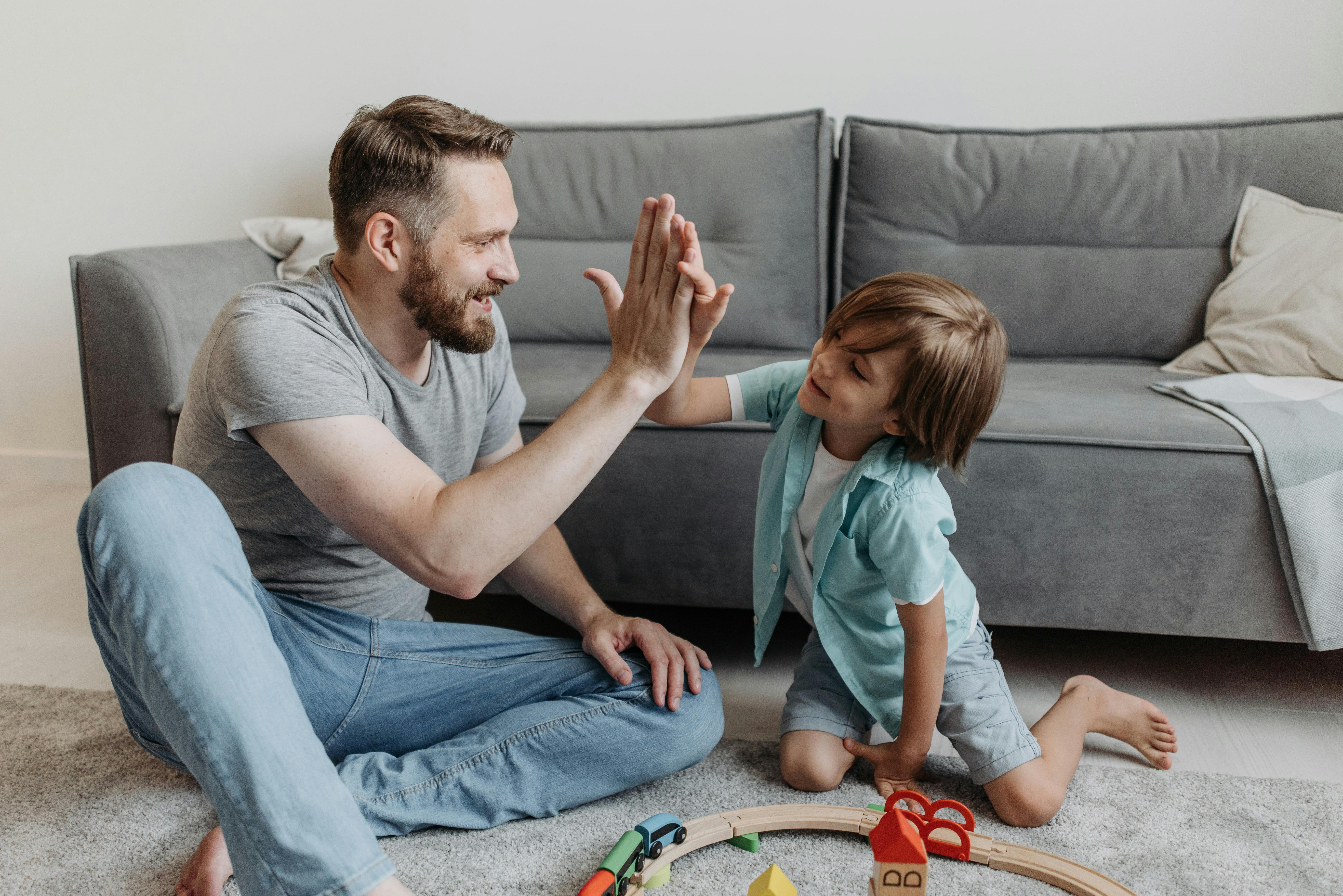 a father and son doing high five