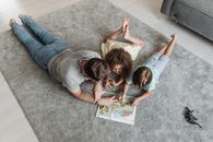 2 Boys Lying on Floor Playing Cards