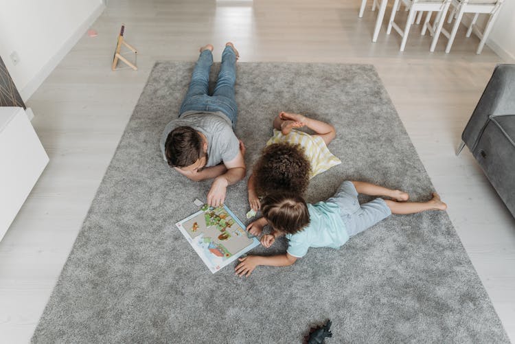 A Man Playing Puzzles Together With His Children