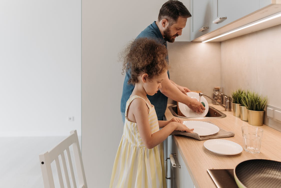 Free A Man Washing the Dishes with His Daughter Stock Photo