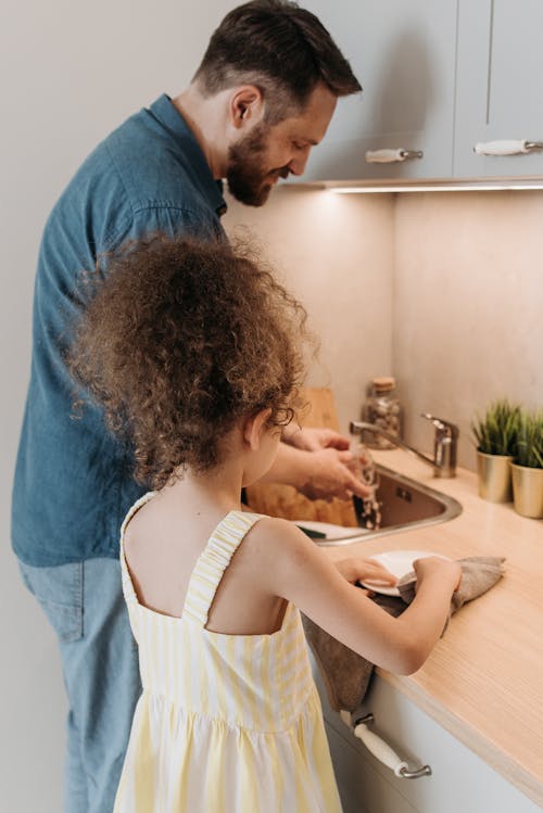 Father and Daughter Doing House Chores Together