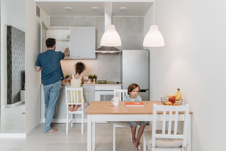 Man In The Kitchen With His Children