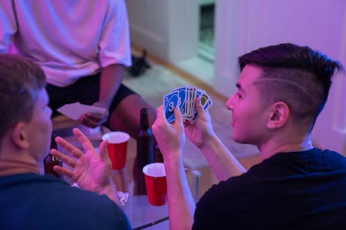 A Man Holding UNO Cards