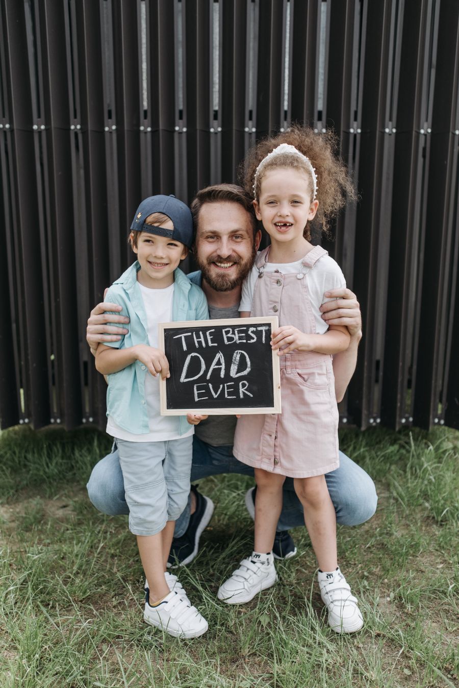 Happy father outdoors with his son and daughter
