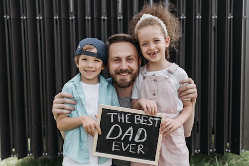 Free A Bearded Man Embracing His Son and Daughter Stock Photo