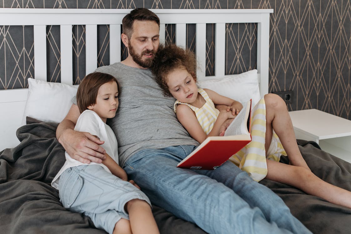 Free Man and his Children on the Bed Stock Photo