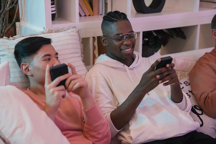 Smiling Guys Playing Retro Video Games On Party