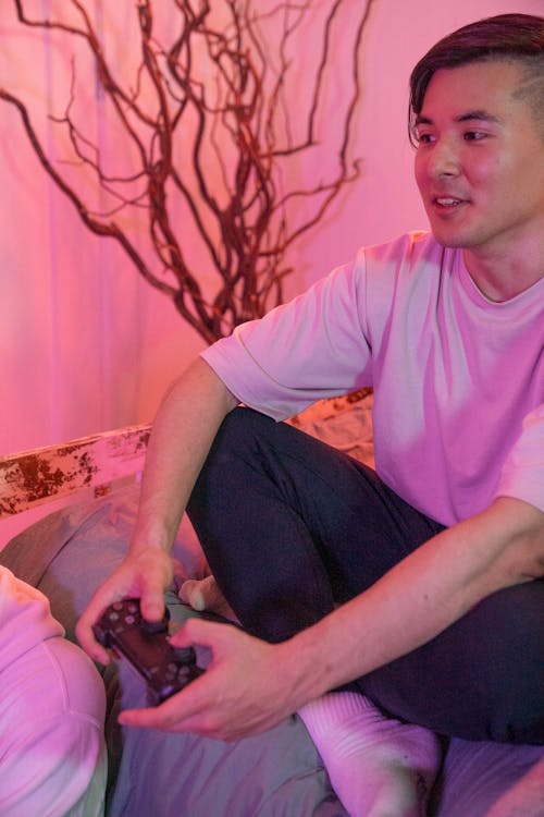 A Man Holding a Wireless Game Controller