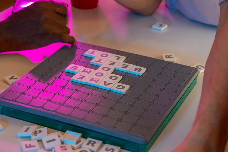 Close-up Of People Playing Board Game At Party