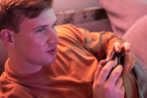 Free Man Playing a Video Game and Holding Joystick  Stock Photo