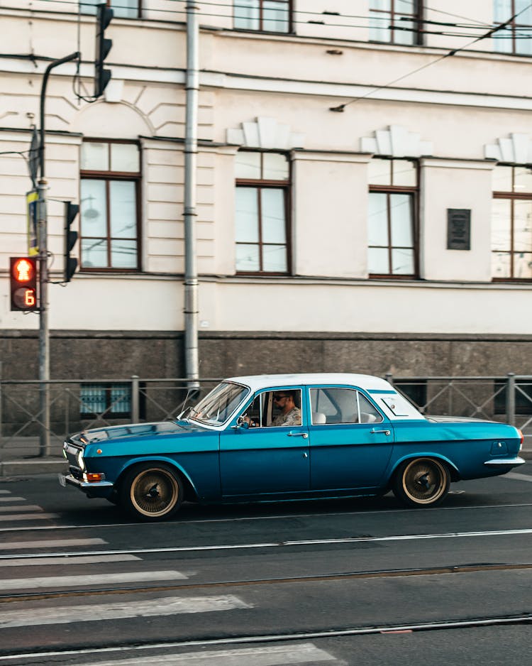 Blue Vintage Car Moving On The Road