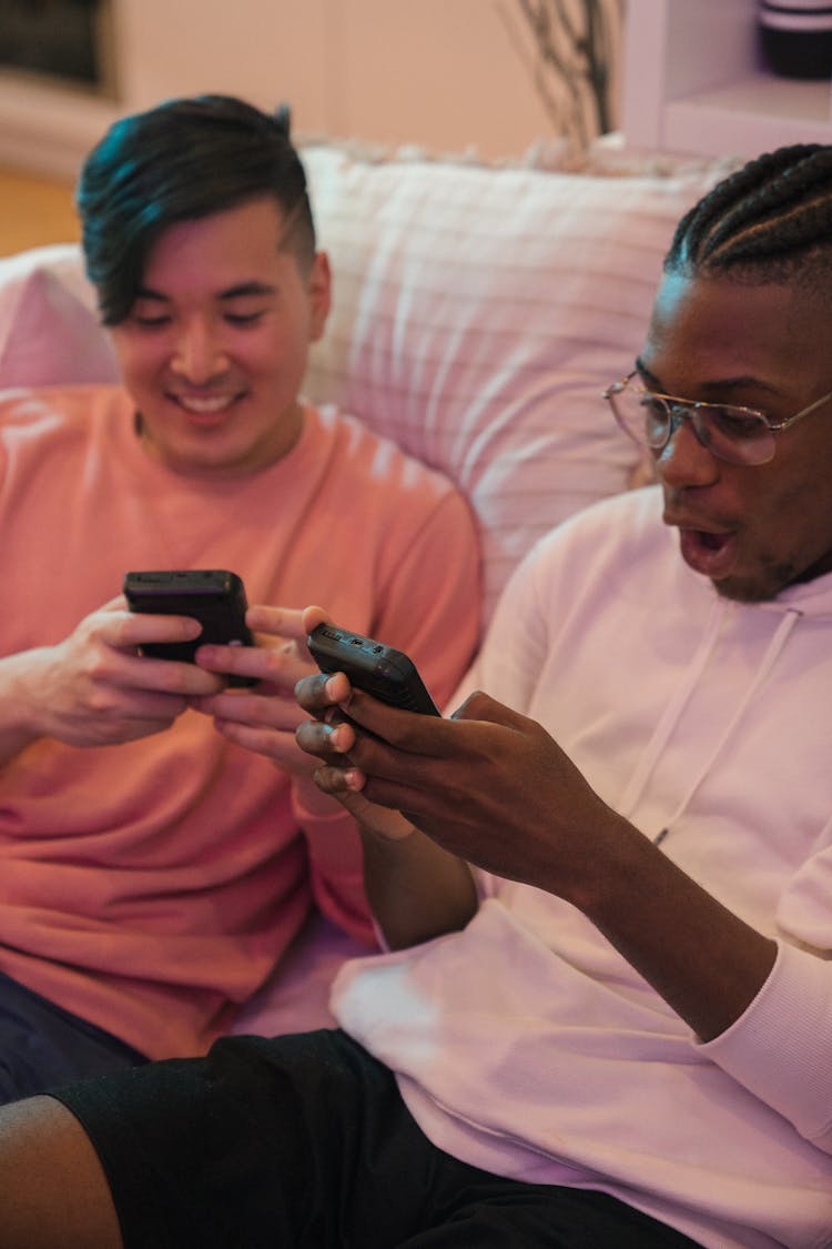 Happy Guys Sitting On Couch Playing Video Games