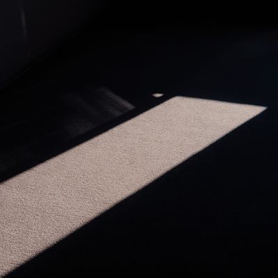 Geometric light on a dark floor — photo by Dmitry Alexandrovich on Pexels