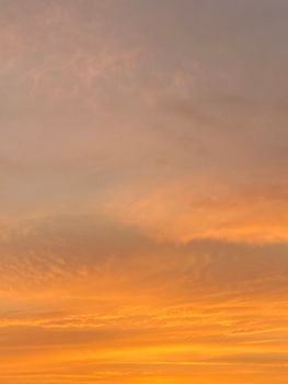 Captivating orange sunset with dramatic clouds creating a serene and scenic view.
