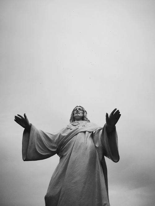 Free Low angle view of a Jesus statue captured in monochrome, evokes spirituality and faith. Stock Photo