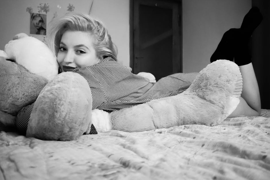Woman Hugging Bear Lying on Bed