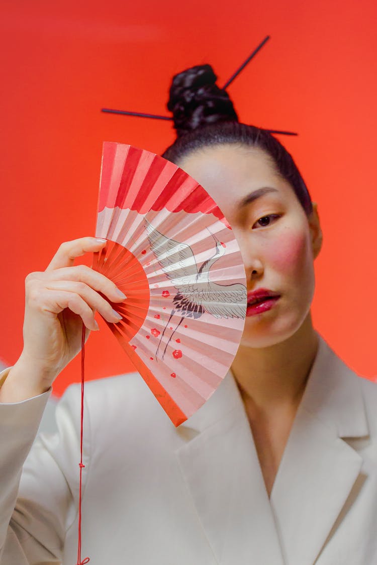 Close Up Photo Of Woman Holding A Fan