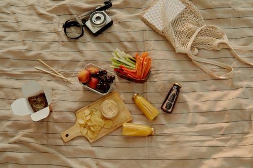 Top View of Food and Drinks Lying on a Picnic Blanket 