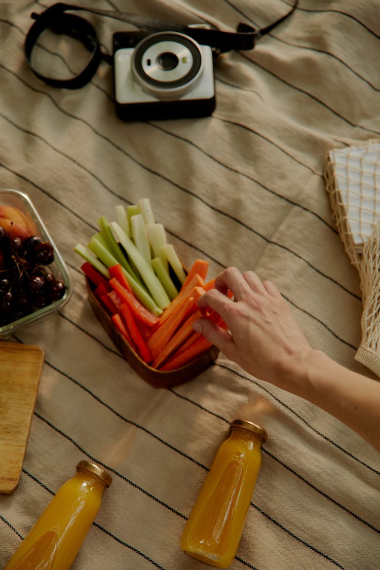 A Hand Picking Sliced Carrot