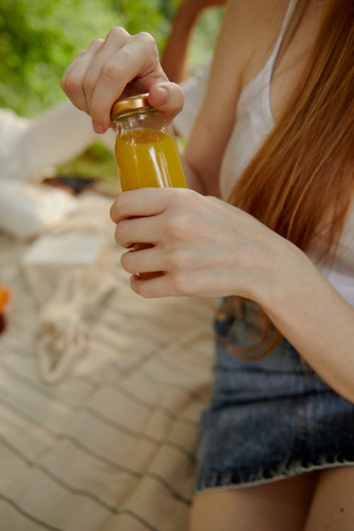 Free Woman Opening a Bottle of Juice Stock Photo