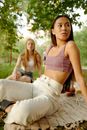 Woman in Pink Sports Bra and White Pants Sitting on Brown Wooden Bench