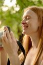 Woman in Black Tank Top Holding Black Smartphone