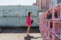 Woman in Pink Dress Standing on Sidewalk