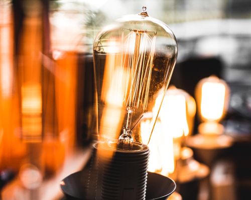 Free Close-up of an Edison light bulb emitting a warm glow, creating a cozy atmosphere indoors. Stock Photo