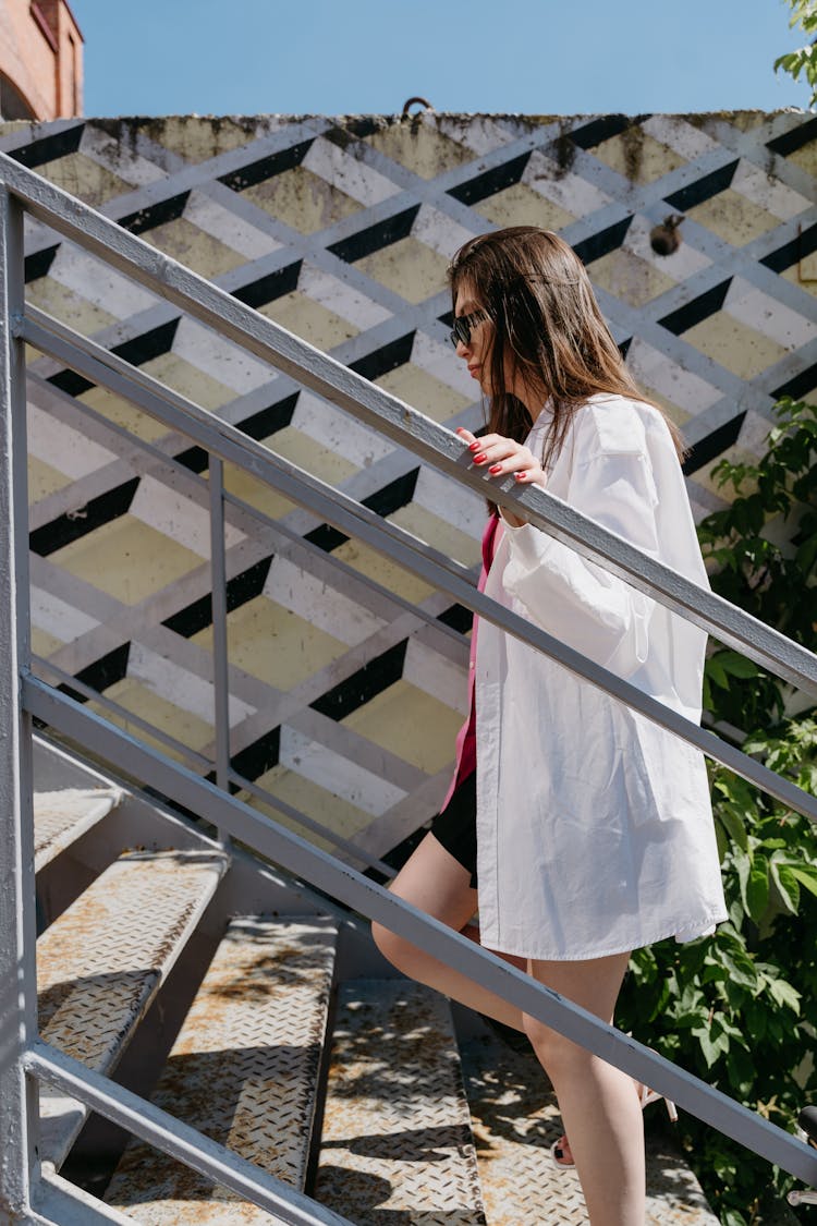 Woman In White Dress Shirt Going Up Using Stairs 