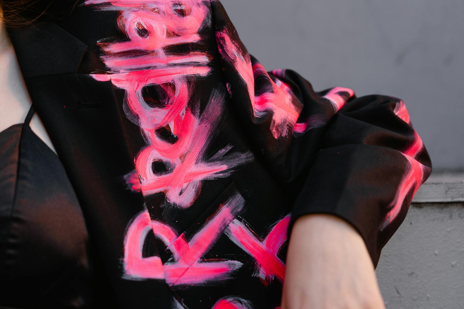 https://www.pexels.com/photo/person-wearing-painted-letters-on-a-black-blazer-8764557/