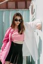 Woman in Pink Dress Shirt and Black Skirt Wearing Sunglasses