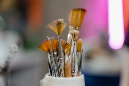 Paint Brushes in White Ceramic Container