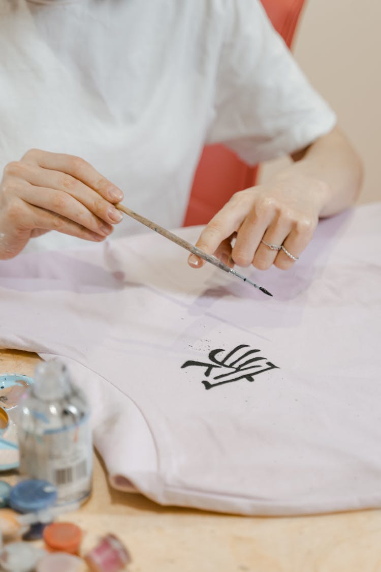 A Person Painting A Shirt