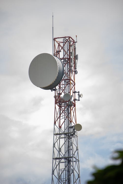 Communication Tower Under White Clouds