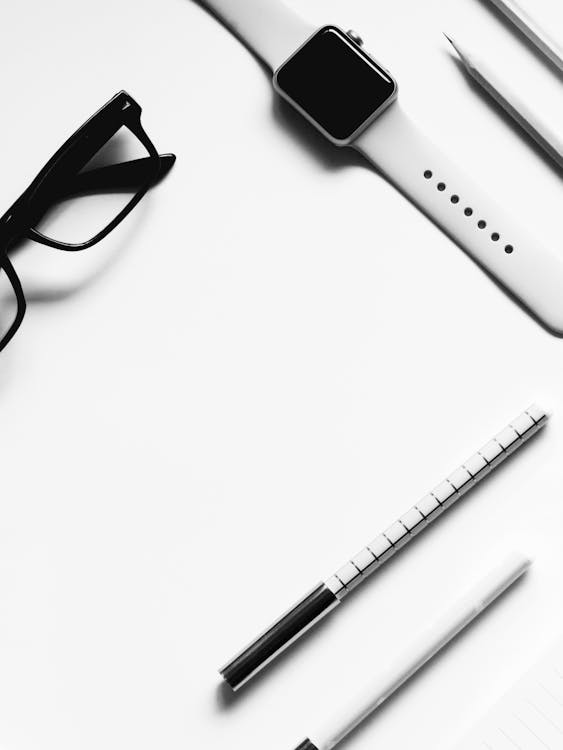 Free Closed Apple Watch Beside Eyeglasses on Table Stock Photo