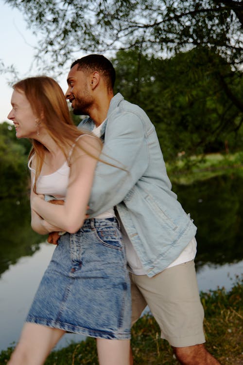 A Man hugging a Woman from Behind 