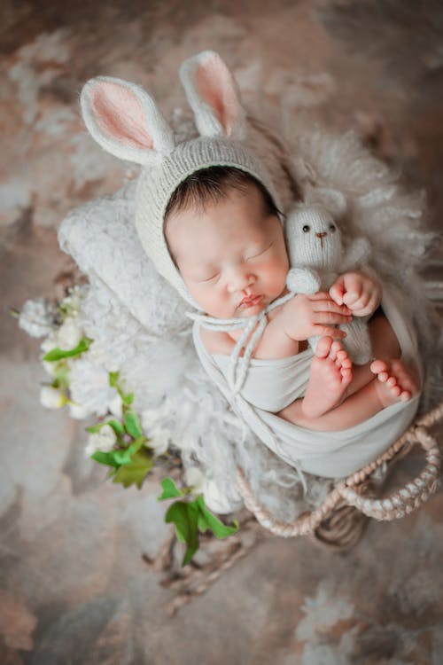 Free Baby Hugging a Bunny Stuffed Toy Stock Photo