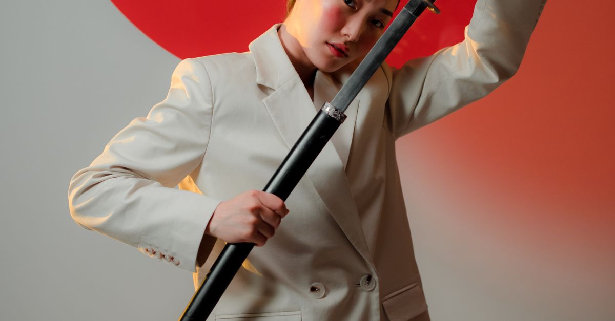 Unsheath A Woman Unsheathing a Sword · Free Stock Photo
