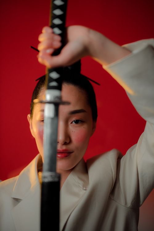Unsheath A Woman Unsheathing a Sword · Free Stock Photo