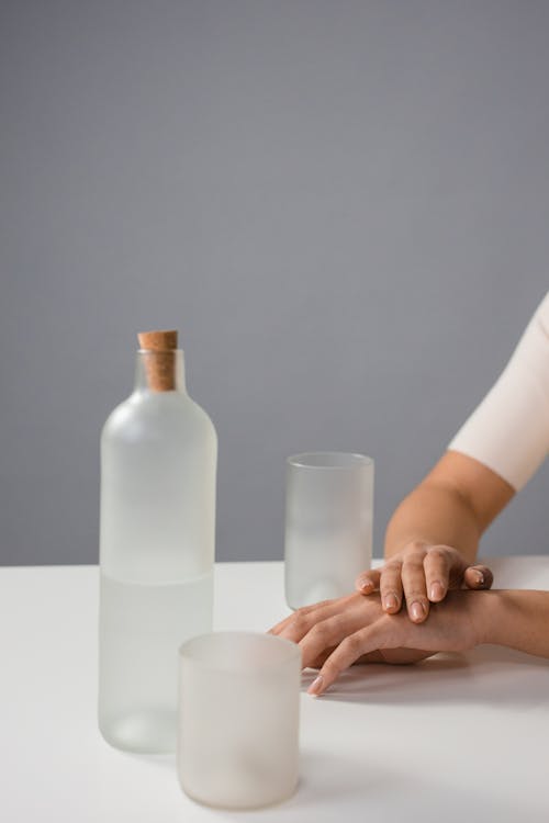 Glass Bottle Beside Drinking Glasses · Free Stock Photo