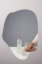 Person Holding Clear Glass Bottle