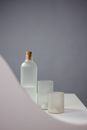 White Ceramic Mug Beside Bottle on Table