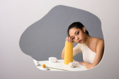 Free Conceptual image of a woman reflected in a mirror, with modern artistic elements. Stock Photo