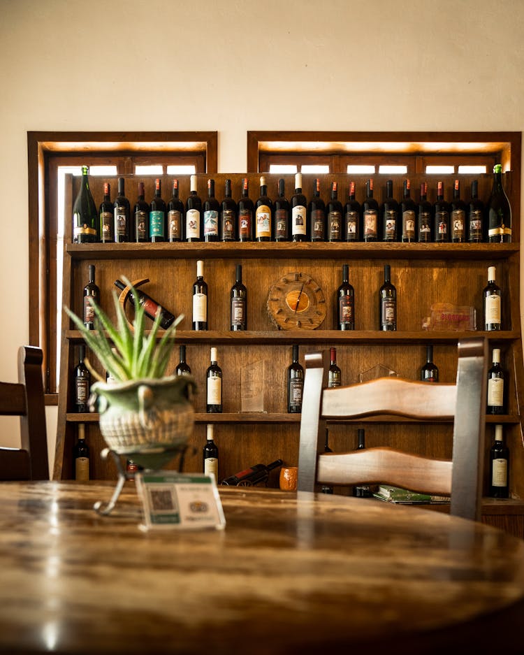 Wine Bottles On A Wooden Shelf