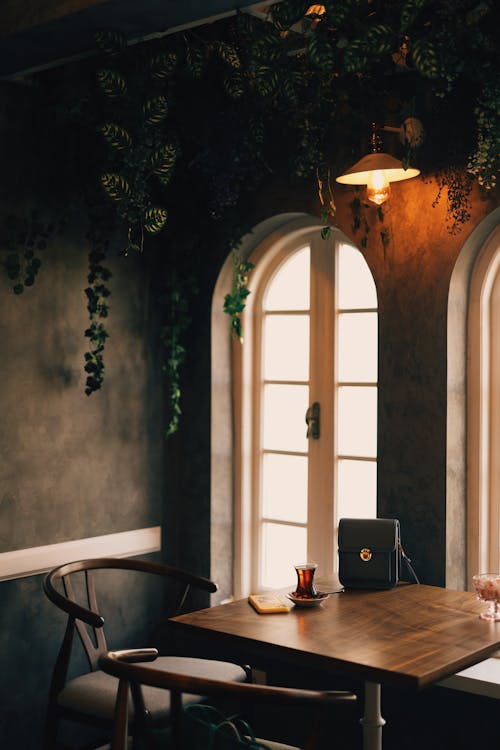 Brown Wooden Table and Chair beside Window 