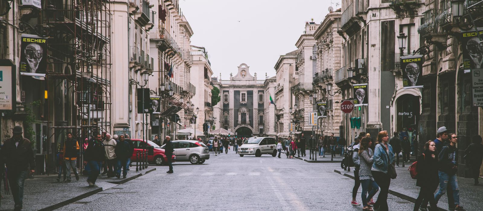 Lively urban scene of a historic street in Catania, Sicily showcasing architecture and daily life. — flights from Milan to Catania