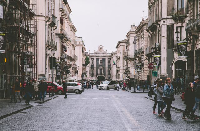 Lively urban scene of a historic street in Catania, Sicily showcasing architecture and daily life. — arriving in Catania