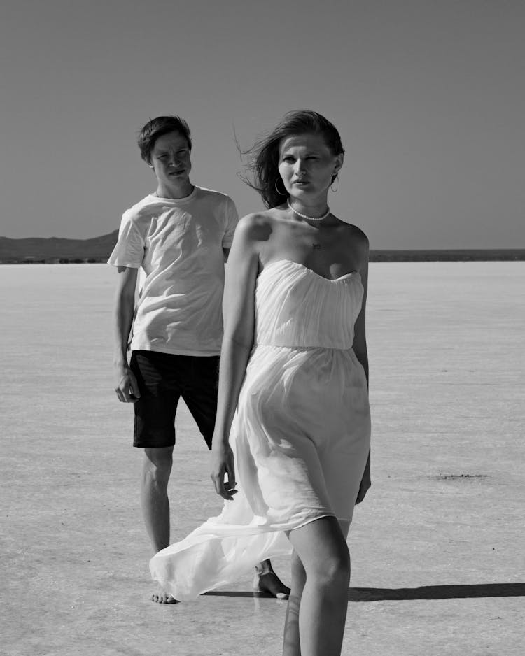 Black And White Photo Of A Man Admiring A Woman From Behind