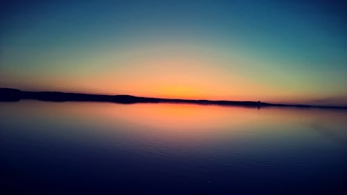 Free Sunset on Body of Water Stock Photo