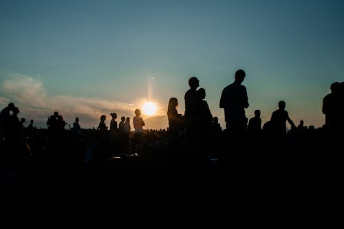 Silhouette of People Standing during a Sunset